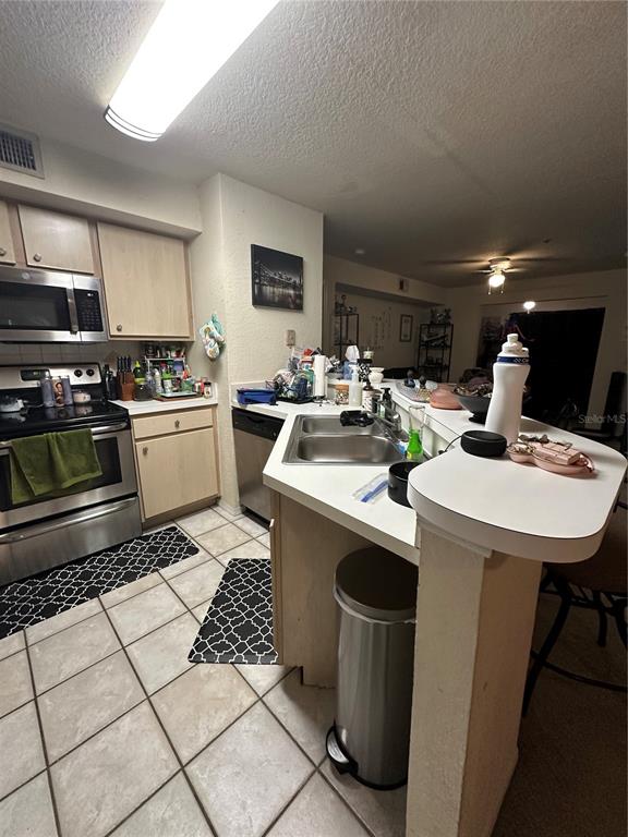 822 Camargo Way, Unit 105 Altamonte Springs, FL 32714 - Photo 8 of 38 a kitchen with a sink a stove and cabinets