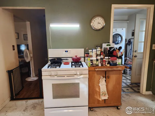 a storage room with washer and clock