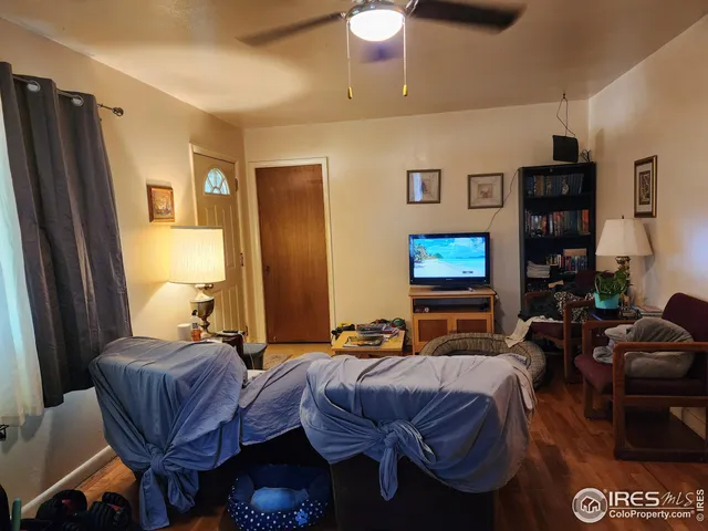 a bedroom with furniture and a flat screen tv