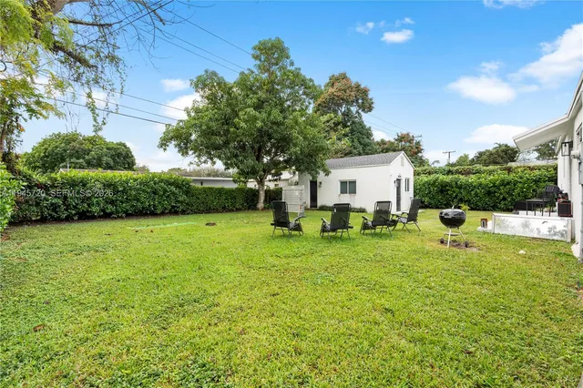 a view of a backyard with large trees