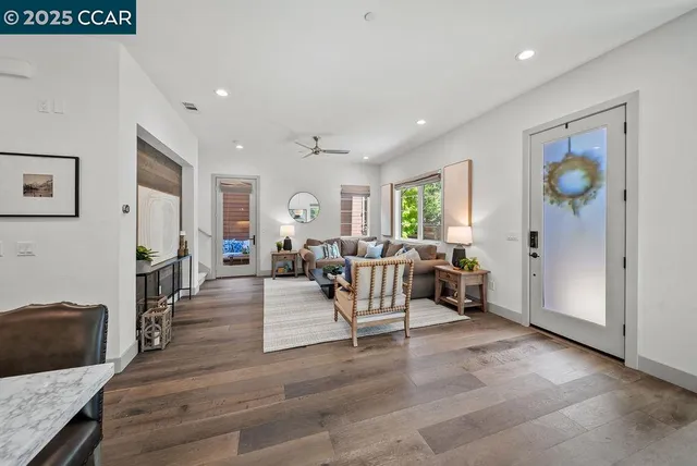 a living room with fireplace furniture and a large window