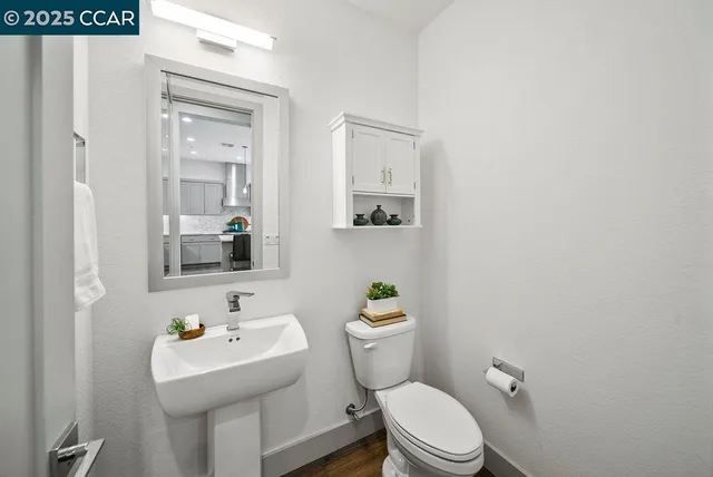 a white toilet sitting next to a bathroom sink