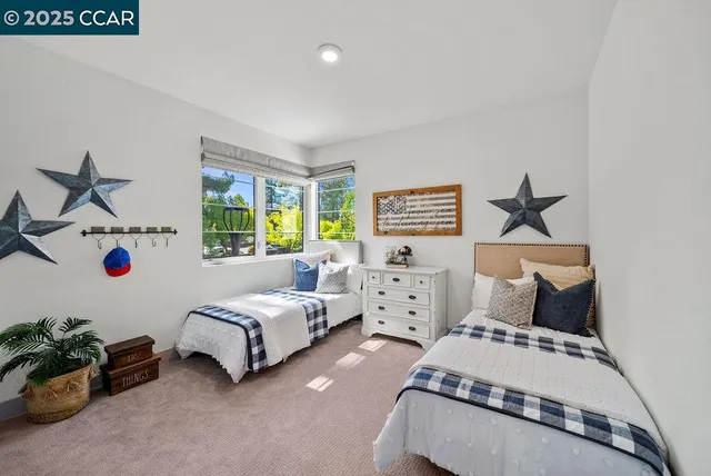 a bedroom with bed and windows