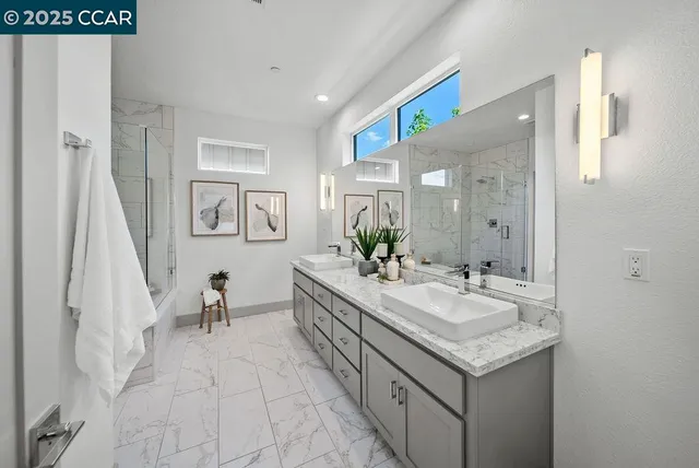 a spacious bathroom with a granite countertop sink and a mirror