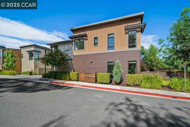 a front view of a house with a garden and plants