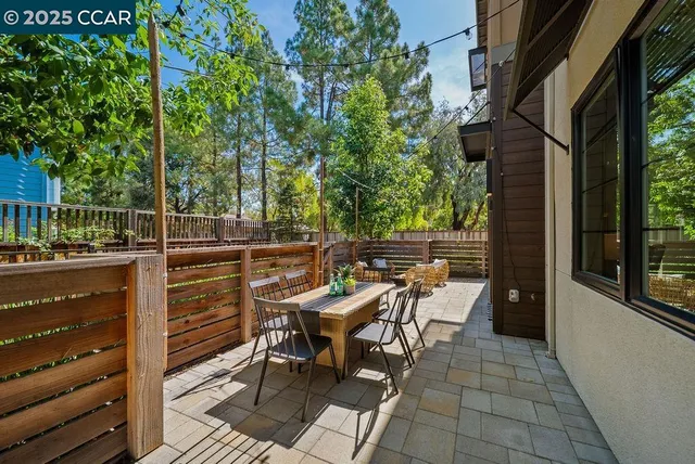 a view of a chairs and table in the backyard