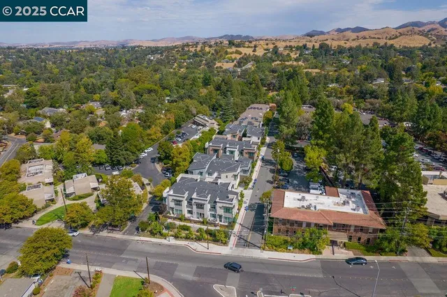 an aerial view of multiple houses with yard