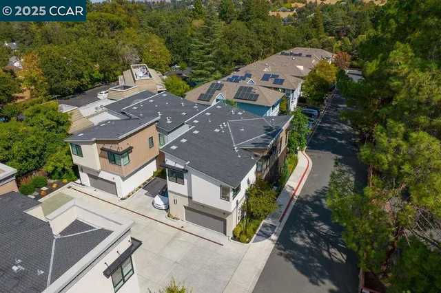 an aerial view of residential houses with outdoor space