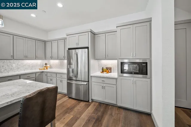 a kitchen with stainless steel appliances a refrigerator stove microwave and sink