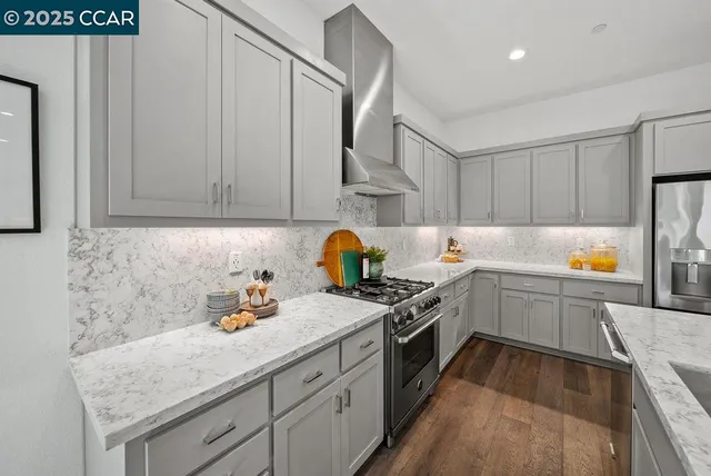 a kitchen with granite countertop a sink stainless steel appliances and cabinets