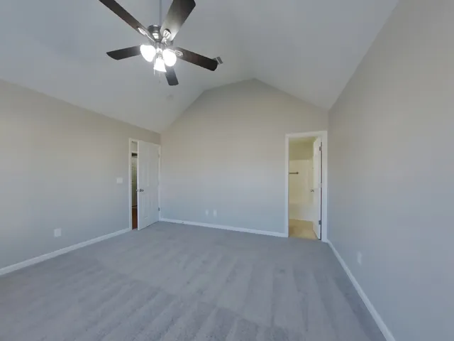 a view of an empty room with a ceiling fan