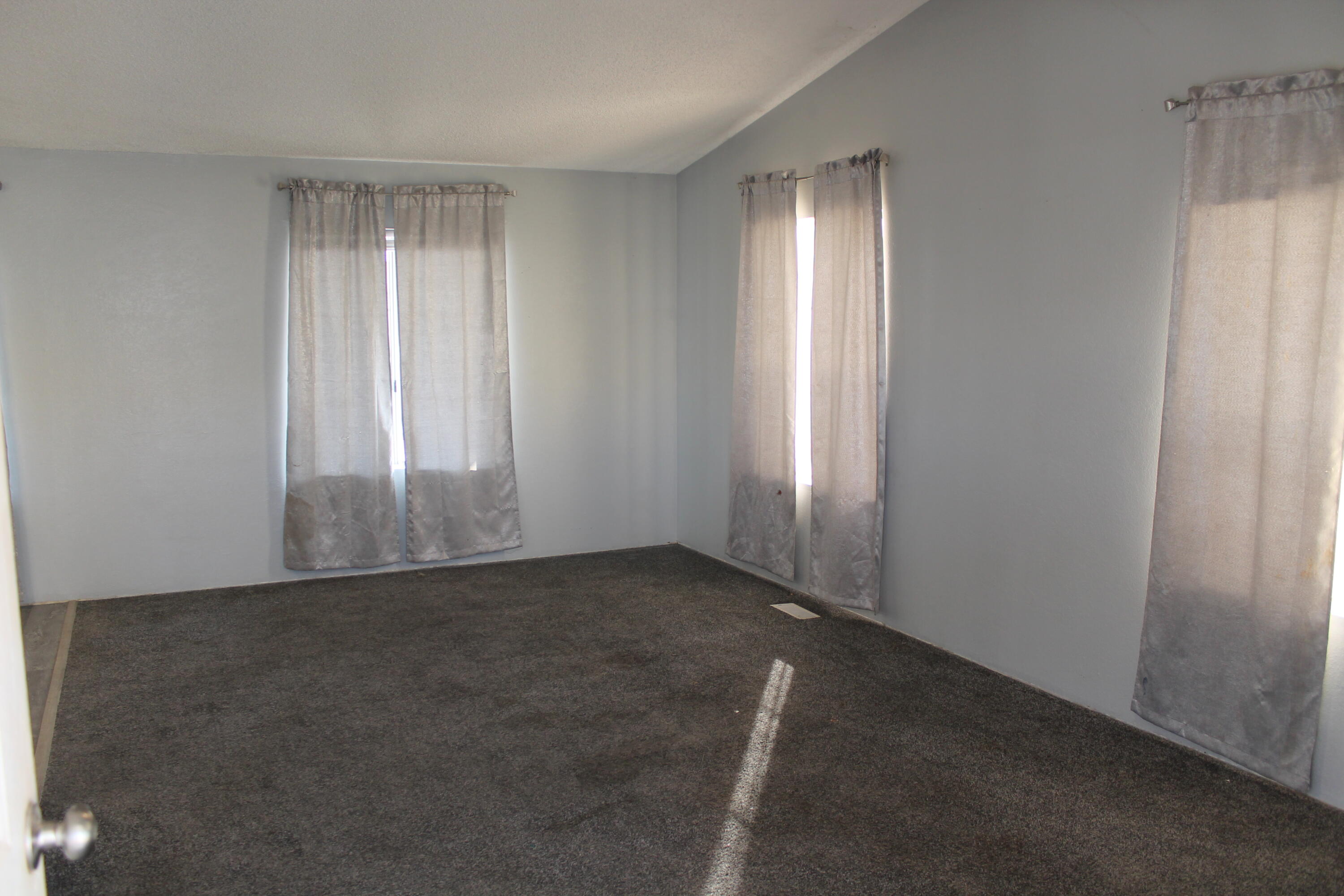 3589 West Wells Road, Unit 64 Blythe, CA 92225 - Photo 6 of 15 an empty room with windows and closet