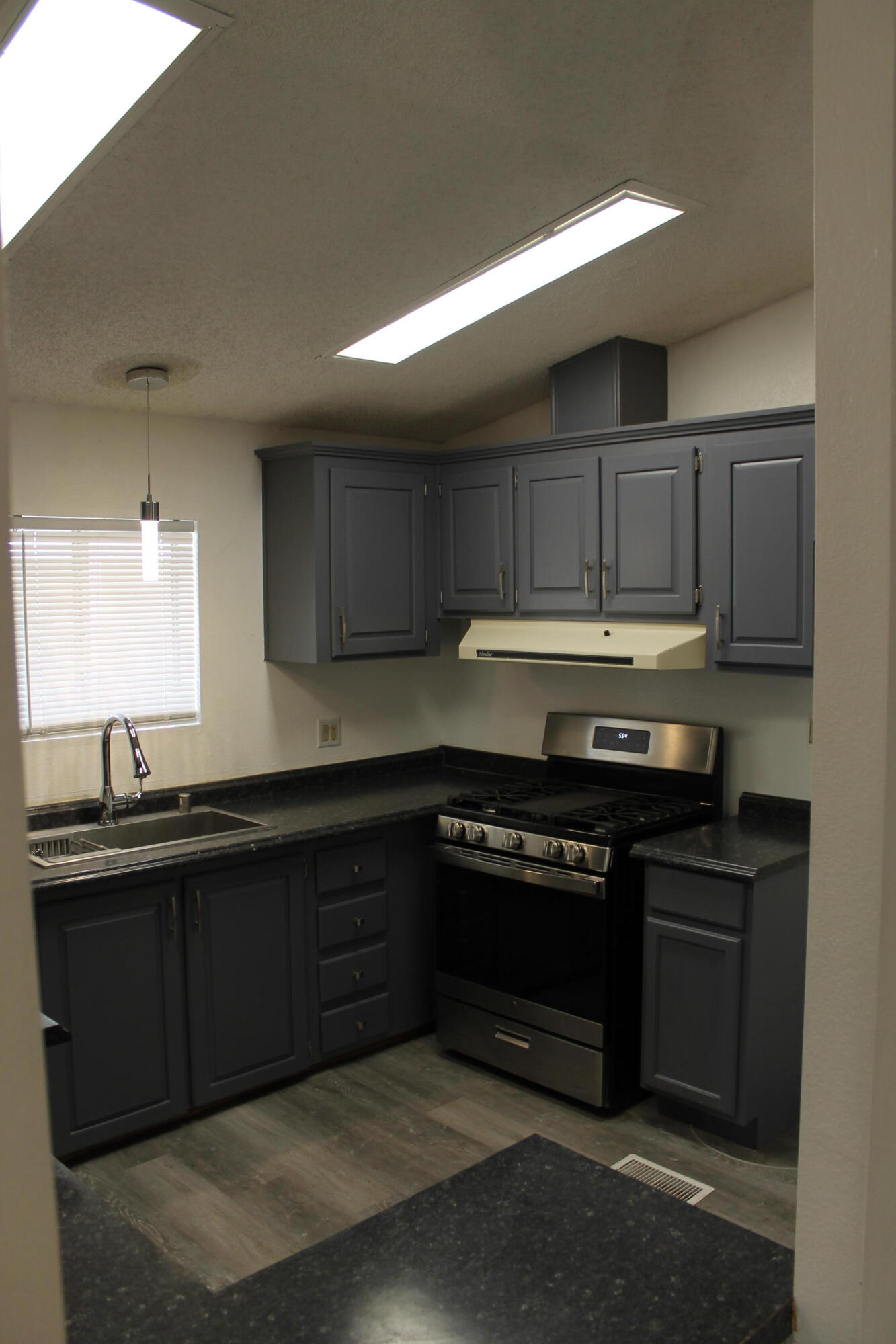 3589 West Wells Road, Unit 64 Blythe, CA 92225 - Photo 7 of 15 a kitchen with stainless steel appliances granite countertop wooden cabinets and a sink