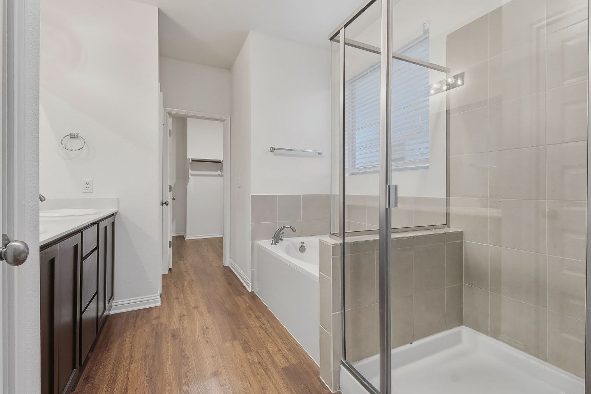 8001 Dampton Lane Austin, TX 78744 - Photo 15 of 38 a bathroom with a bathtub a toilet and a shower