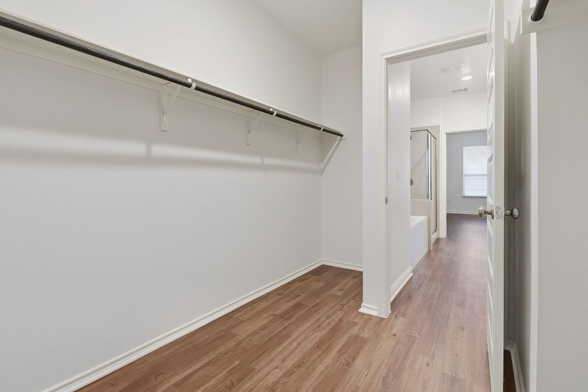 8001 Dampton Lane Austin, TX 78744 - Photo 18 of 38 a view of a hallway with wooden floor