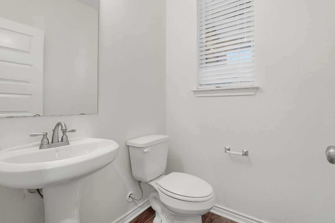 8001 Dampton Lane Austin, TX 78744 - Photo 19 of 38 a bathroom with a sink a toilet and mirror