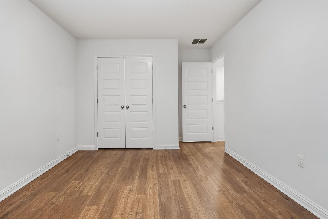 8001 Dampton Lane Austin, TX 78744 - Photo 22 of 38 a view of an empty room with wooden floor