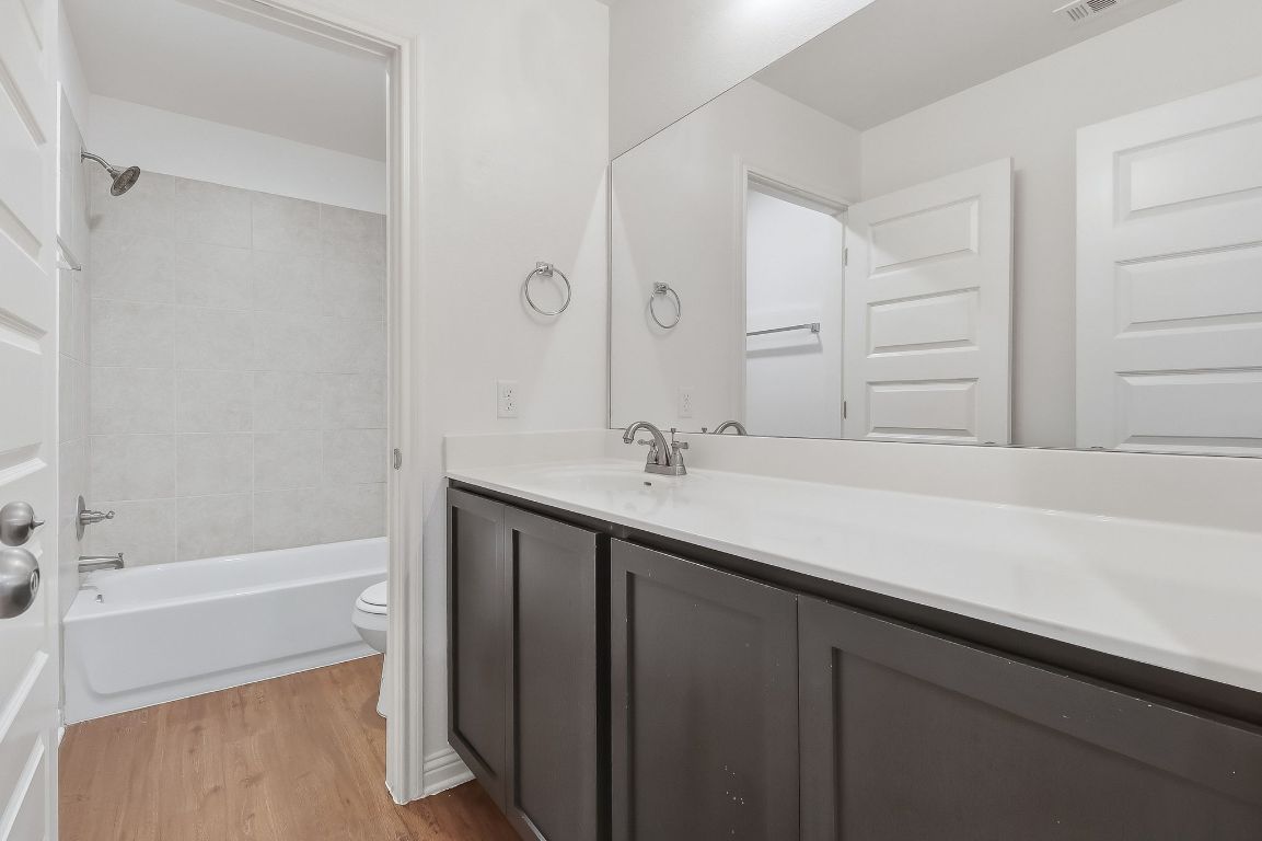 8001 Dampton Lane Austin, TX 78744 - Photo 23 of 38 a bathroom with a sink and a bathtub