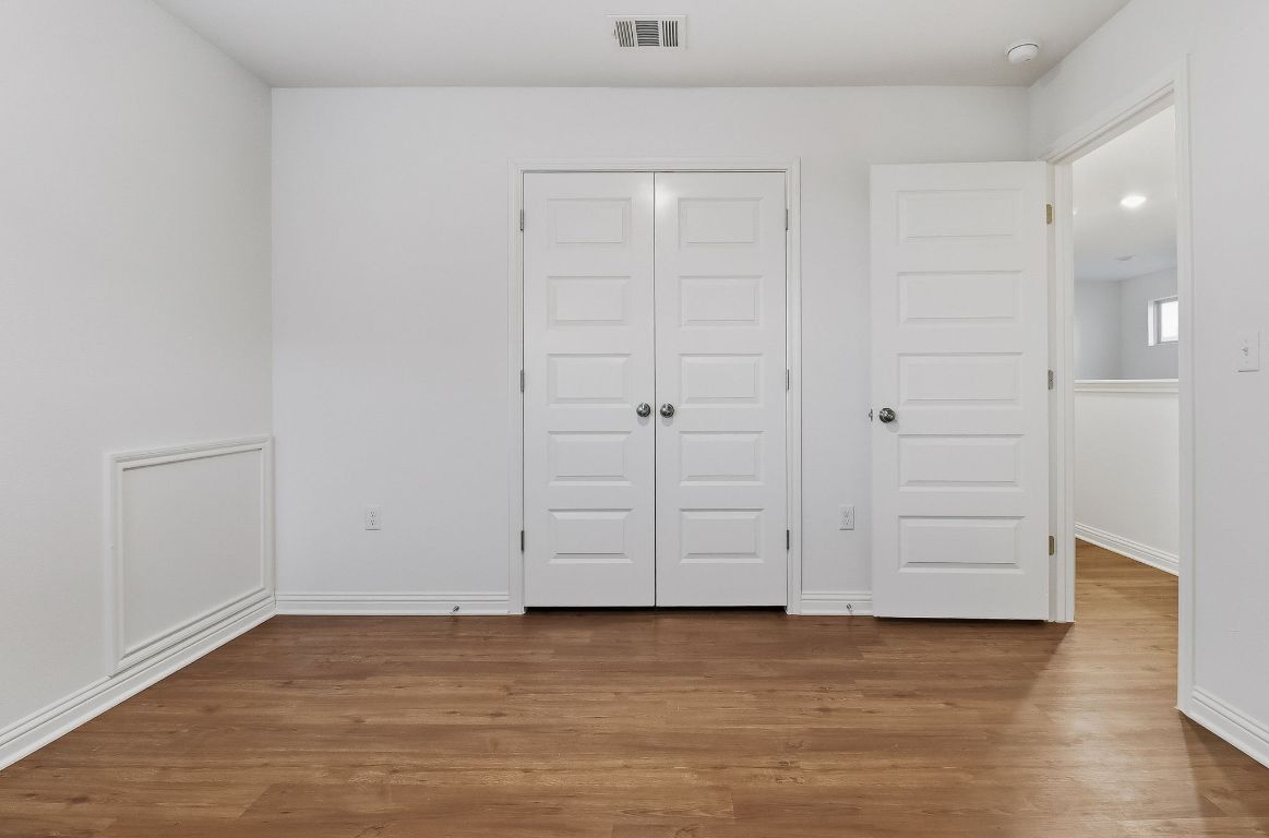 8001 Dampton Lane Austin, TX 78744 - Photo 27 of 38 a view of an empty room with wooden floor