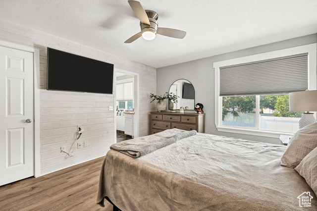 2280 South 450 West Perry, UT 84302 - Photo 15 of 38 Bedroom with wood finished floors, wood walls, and a ceiling fan