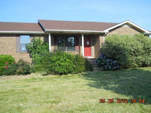 604 Jake Link Road Cottontown, TN 37048 - Photo 1 of 20 a front view of a house with garden