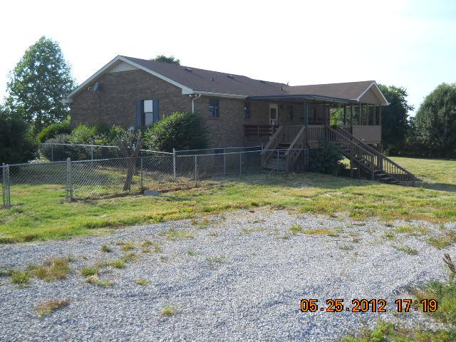 604 Jake Link Road Cottontown, TN 37048 - Photo 13 of 20 a view of a house with a backyard and a patio