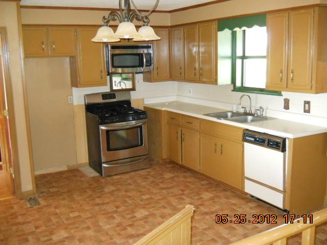 604 Jake Link Road Cottontown, TN 37048 - Photo 10 of 20 a kitchen with granite countertop a sink stainless steel appliances and cabinets