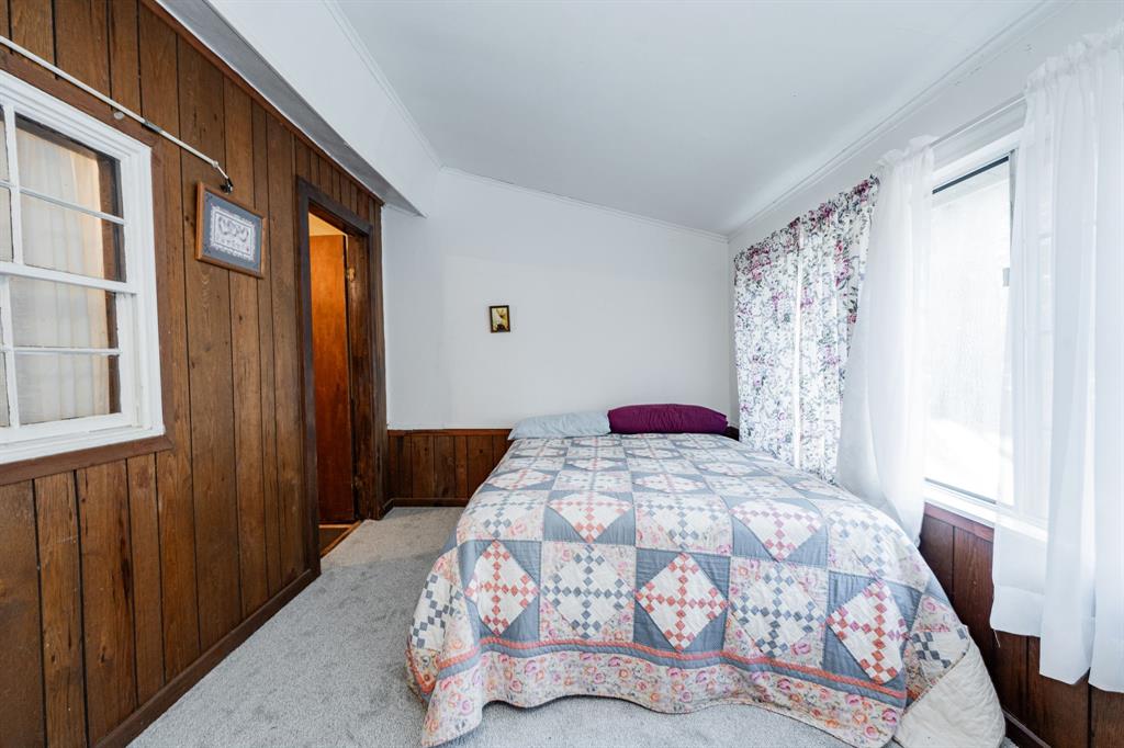 2712 Kleberg Road, Unit B Seagoville, TX 75159 - Photo 17 of 40 Bedroom with wooden walls, ornamental molding, and carpet floors