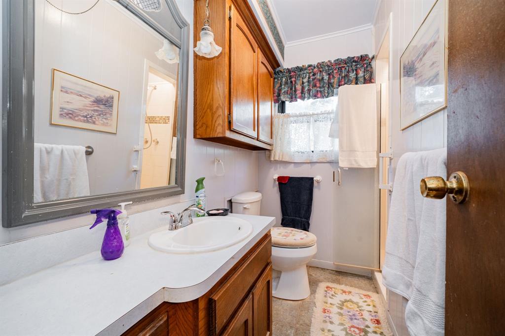 2712 Kleberg Road, Unit B Seagoville, TX 75159 - Photo 19 of 40 Bathroom featuring ornamental molding, vanity, and a shower