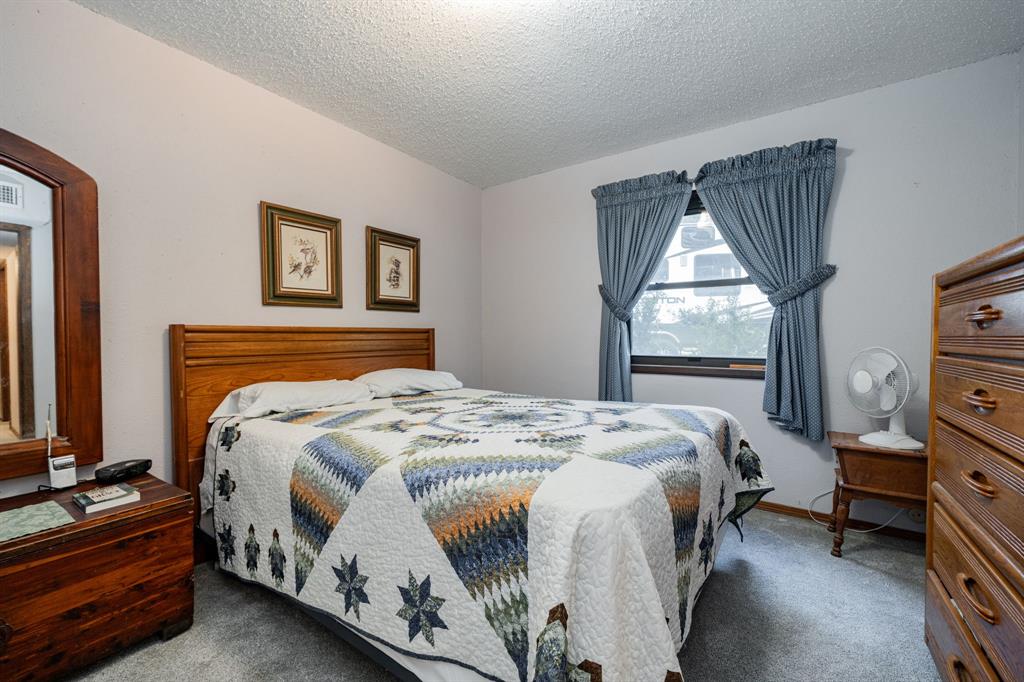 2712 Kleberg Road, Unit B Seagoville, TX 75159 - Photo 20 of 40 Bedroom with a textured ceiling and carpet flooring