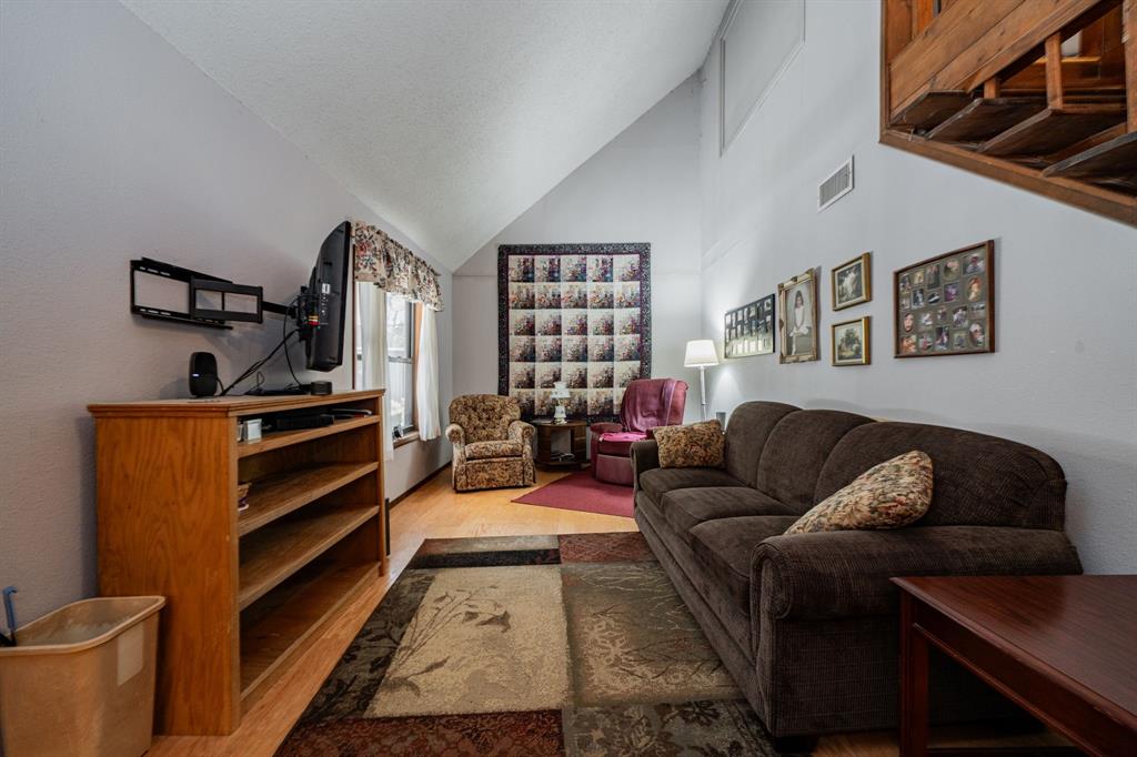 2712 Kleberg Road, Unit B Seagoville, TX 75159 - Photo 25 of 40 Living area with vaulted ceiling and light wood-style flooring