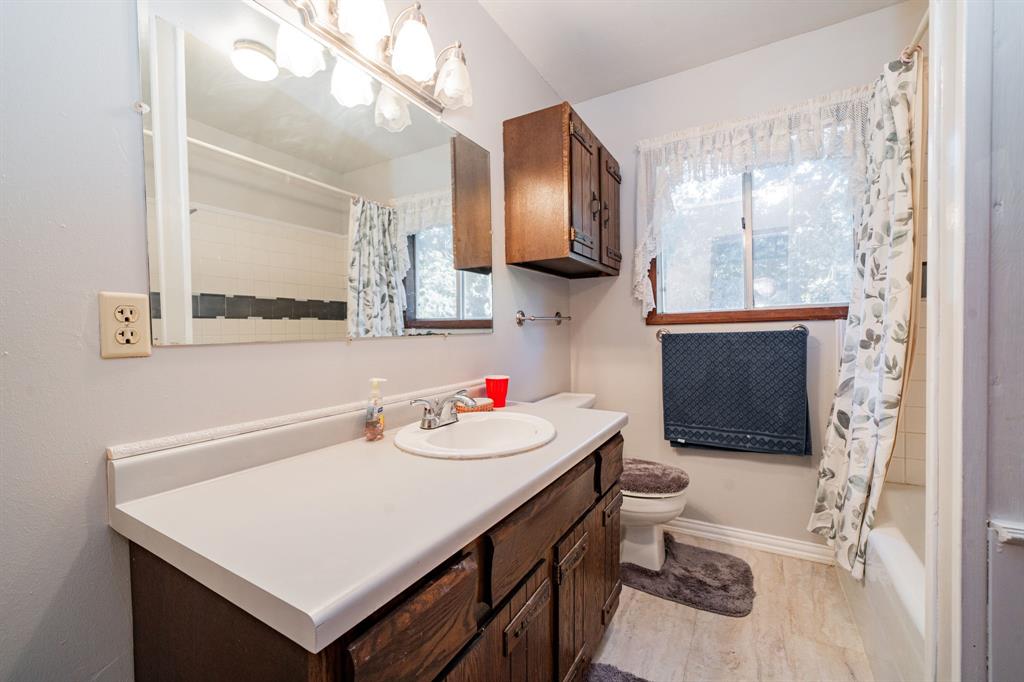 2712 Kleberg Road, Unit B Seagoville, TX 75159 - Photo 29 of 40 Bathroom featuring vanity, shower / bath combination with curtain, and healthy amount of natural light