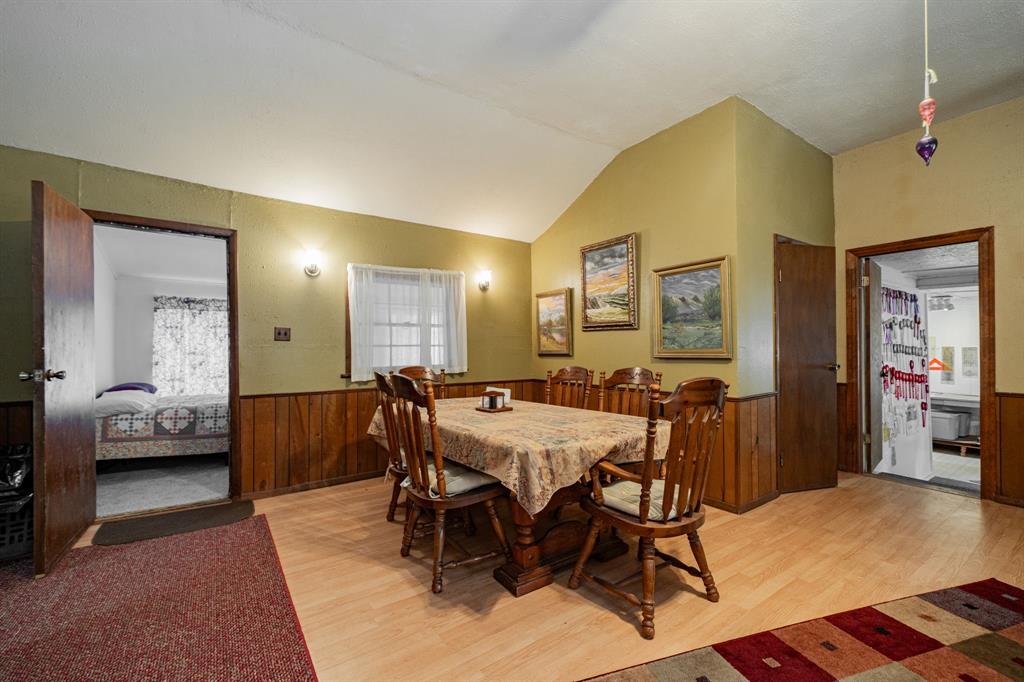 2712 Kleberg Road, Unit B Seagoville, TX 75159 - Photo 8 of 40 Dining space with a wainscoted wall, light wood finished floors, wood walls, and lofted ceiling