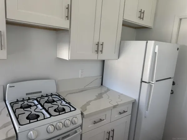 a kitchen with a stove and a refrigerator
