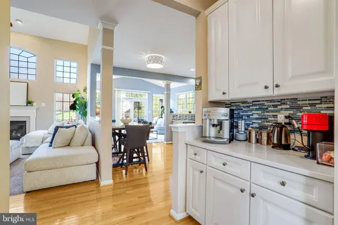 a living room with furniture and a dining table with kitchen view