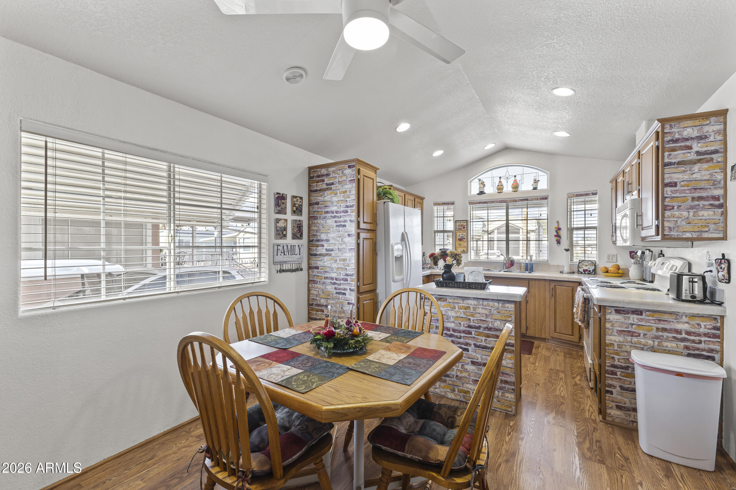 17200 West Bell Road, Unit 548 Surprise, AZ 85374 - Photo 9 of 19 a view of a dining room with furniture window and wooden floor