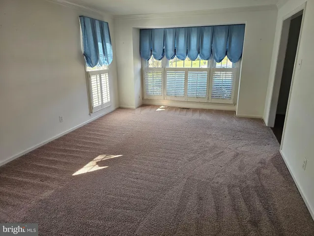 a view of a room with wooden walls and window