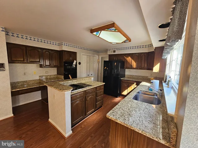 a kitchen with stainless steel appliances granite countertop a stove and a sink