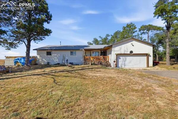 a large pool with lawn chairs under an umbrella
