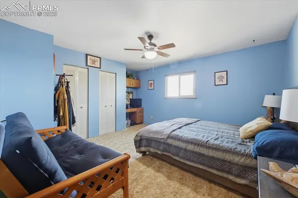 a bedroom with bed and a chandelier