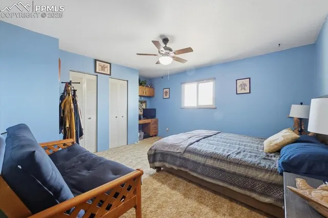 a bedroom with bed and a chandelier