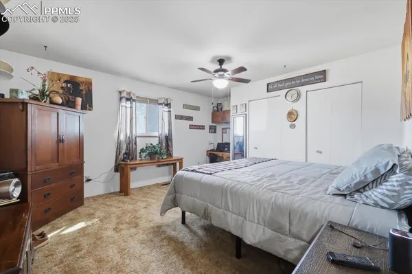 a bed room with a bed and a refrigerator