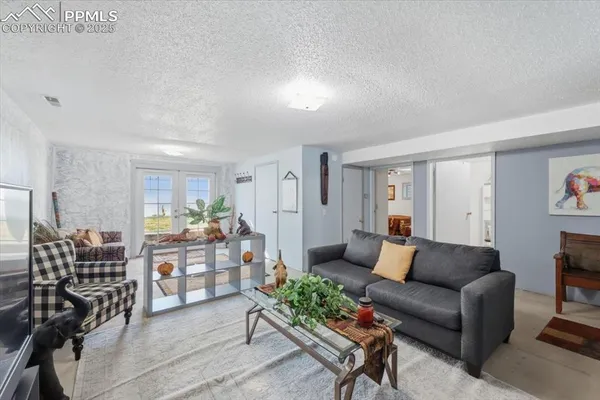 a living room with furniture and wooden floor