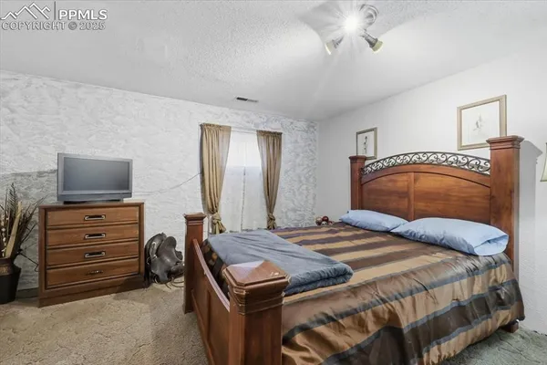 a bedroom with a bed and a television