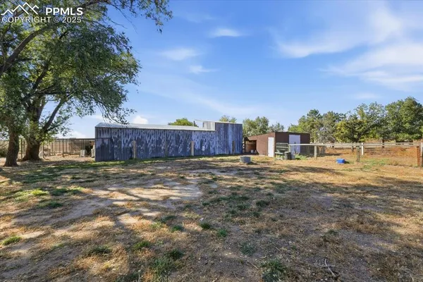 a view of a house with backyard and tree