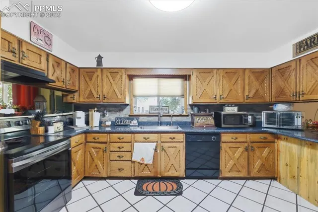 a kitchen with stainless steel appliances granite countertop a stove a sink dishwasher and cabinets with wooden floor