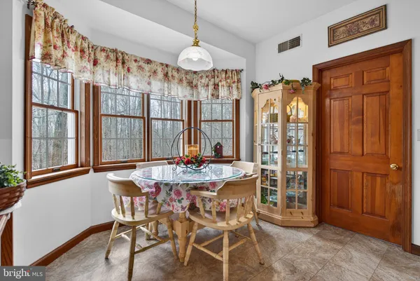 a dining table with chairs and a chandelier