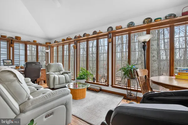 a living room with furniture and floor to ceiling windows