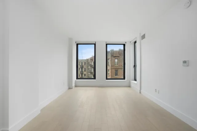 a view of a kitchen with an empty space and a window