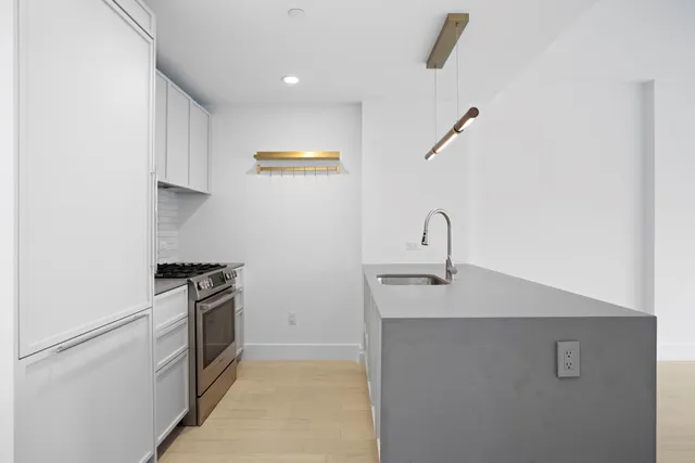 a view of an empty room with windows and closet